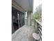 View of a balcony with a sliding door to the interior and exterior view and stool at 2967 Eagles Crest Cir # C, Indianapolis, IN 46214