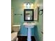 The renovated bathroom features a pedestal sink, a classic mirror, and a ceramic toilet at 2967 Eagles Crest Cir # C, Indianapolis, IN 46214