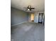 Carpeted bedroom features a ceiling fan and neutral walls with doorways leading to other rooms at 2967 Eagles Crest Cir # C, Indianapolis, IN 46214