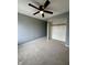A cozy bedroom features neutral paint, a ceiling fan, and an open closet at 2967 Eagles Crest Cir # C, Indianapolis, IN 46214