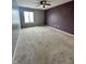 Spacious bedroom with plush carpeting, ceiling fan, and natural light from the window at 2967 Eagles Crest Cir # C, Indianapolis, IN 46214