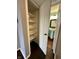 An organized closet features many shelves and hardwood floors with the view to the bathroom at 2967 Eagles Crest Cir # C, Indianapolis, IN 46214