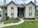 Well-maintained condo building exterior with landscaped grounds, walkway, and central staircase at 2967 Eagles Crest Cir # C, Indianapolis, IN 46214