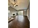 Spacious living room with dark wood floors, fireplace, and sliding doors to a balcony at 2967 Eagles Crest Cir # C, Indianapolis, IN 46214