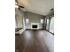 Living room featuring a fireplace, dark wood floors and sliding doors to a balcony at 2967 Eagles Crest Cir # C, Indianapolis, IN 46214