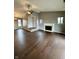 Open concept living room with fireplace, dark wood floors and neutral colored walls at 2967 Eagles Crest Cir # C, Indianapolis, IN 46214