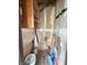 Unfinished utility space with shelves, paint bucket, and cleaning supplies stored inside at 2967 Eagles Crest Cir # C, Indianapolis, IN 46214