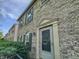 Brick townhouse featuring a front door entrance with beautiful trim and garden view at 3078 Armory Dr, Indianapolis, IN 46208