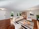 Bright living room featuring hardwood floors, stylish furniture, and arched windows with green view at 3078 Armory Dr, Indianapolis, IN 46208