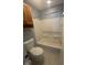 Clean bathroom with a white toilet, a shower-tub combo, and a wooden vanity at 317 Legacy Blvd, Greenwood, IN 46143
