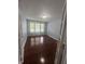 Well-lit bedroom featuring hardwood floors and three windows that bring in natural light at 317 Legacy Blvd, Greenwood, IN 46143