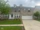 Traditional two-story brick home with a two-car garage and well-maintained lawn at 317 Legacy Blvd, Greenwood, IN 46143