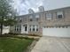 Attractive two-story brick home with dormer windows, a two-car garage, and a well-manicured lawn at 317 Legacy Blvd, Greenwood, IN 46143