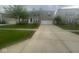 Residential house featuring mature landscaping and a spacious driveway at 317 Legacy Blvd, Greenwood, IN 46143
