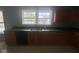 Neutral kitchen featuring wood cabinets, a double basin sink, and views from the window at 317 Legacy Blvd, Greenwood, IN 46143