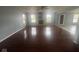 Open living room with a stone fireplace, hardwood floors, and bright, natural light at 317 Legacy Blvd, Greenwood, IN 46143