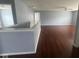 Spacious open-concept living room with hardwood floors and neutral paint, bright with natural light at 317 Legacy Blvd, Greenwood, IN 46143