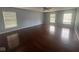 A spacious main bedroom offers gorgeous hardwood floors and ample natural light through three bright windows at 317 Legacy Blvd, Greenwood, IN 46143