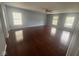 A spacious main bedroom offers gorgeous hardwood floors and ample natural light through three bright windows at 317 Legacy Blvd, Greenwood, IN 46143