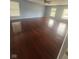 A spacious main bedroom offers gorgeous hardwood floors and ample natural light through three bright windows at 317 Legacy Blvd, Greenwood, IN 46143