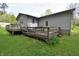 Spacious yard view of the home's weathered wooden deck at 3282 S Conservation Club Rd, Morgantown, IN 46160