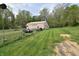 View of the property's large barn in a grassy field at 3282 S Conservation Club Rd, Morgantown, IN 46160