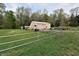 View of the property's large barn with a fenced pasture at 3282 S Conservation Club Rd, Morgantown, IN 46160