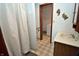 Bathroom featuring a wood vanity, a shower and doorway leading to the laundry area at 3282 S Conservation Club Rd, Morgantown, IN 46160
