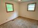 Bedroom featuring wall-to-wall carpet, windows for natural light, and neutral wall color at 3282 S Conservation Club Rd, Morgantown, IN 46160