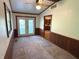 Dining area featuring wainscoting, a ceiling fan, and natural light from French doors at 3282 S Conservation Club Rd, Morgantown, IN 46160
