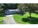 Charming single-story home with a well-maintained lawn, gravel driveway, and mature trees providing shade at 3282 S Conservation Club Rd, Morgantown, IN 46160