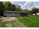 Cozy single-story home with a gray exterior, attached garage, and a well-maintained green lawn at 3282 S Conservation Club Rd, Morgantown, IN 46160