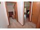 Hallway view showcasing wood trim, doorway access to bedrooms, and neutral walls at 3282 S Conservation Club Rd, Morgantown, IN 46160