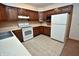 Traditional kitchen features wood cabinets and white appliances at 3282 S Conservation Club Rd, Morgantown, IN 46160