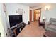 Inviting living room featuring laminate flooring, a modern TV setup, and neutral-toned decor at 3282 S Conservation Club Rd, Morgantown, IN 46160