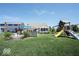 Large backyard with play set, outdoor kitchen, and plenty of space for entertaining at 3311 Stoddard Pl, Indianapolis, IN 46217