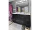 Gray bathroom features a double vanity, large mirror, and a tiled floor at 3311 Stoddard Pl, Indianapolis, IN 46217