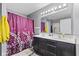 Well-lit bathroom has a double vanity and shower with floral print at 3311 Stoddard Pl, Indianapolis, IN 46217