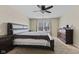 Comfortable bedroom features a sleek bed, window and closet with dark wood dresser at 3311 Stoddard Pl, Indianapolis, IN 46217