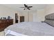 Spacious bedroom features a comfortable bed, ceiling fan, and dark wood furnishings at 3311 Stoddard Pl, Indianapolis, IN 46217