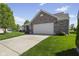 This lovely home boasts a brick facade, two-car garage, and a neatly kept lawn at 3311 Stoddard Pl, Indianapolis, IN 46217