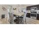 Open-concept kitchen and dining area with stylish wood-look floors and modern appliances at 3311 Stoddard Pl, Indianapolis, IN 46217
