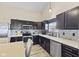 Well-equipped kitchen boasts dark cabinets, light countertops, stainless steel appliances, and tiled backsplash at 3311 Stoddard Pl, Indianapolis, IN 46217