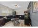Open concept living room with dark sofa, plank floors, and large windows at 3311 Stoddard Pl, Indianapolis, IN 46217