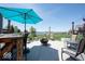 This open-air patio features an umbrella for shade, a fire pit, and seating, perfect for enjoying the outdoors at 3311 Stoddard Pl, Indianapolis, IN 46217