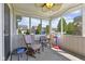 A screened-in porch with comfortable seating offers an inviting space to enjoy the outdoors at 3311 Stoddard Pl, Indianapolis, IN 46217