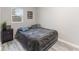 Bedroom with fresh paint, light wood floor, decor, and large covered bed at 3331 Graceland Ave, Indianapolis, IN 46208
