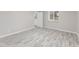 Bright bedroom featuring a light wood floor, fresh paint, and a window at 3331 Graceland Ave, Indianapolis, IN 46208