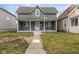 Charming two-story home with a welcoming front porch and gray siding at 3331 Graceland Ave, Indianapolis, IN 46208