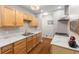 Traditional kitchen features wood cabinets, marble counters, and modern appliances at 3331 Graceland Ave, Indianapolis, IN 46208